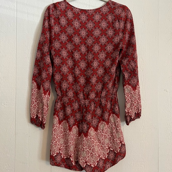 Red printed long sleeve romper. Sinched tie up detail in front with tassels - Picture 3 of 3
